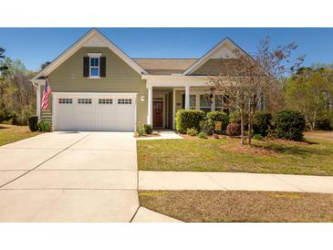 Charming single Gathering home featuring a spacious driveway and manicured lawn with mature shrubs at 126 Citrea Dr, Summerville, SC 29483