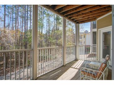 This is a beautiful balcony with two chairs that is facing a forest at 1413 Basildon Rd, Mount Pleasant, SC 29466
