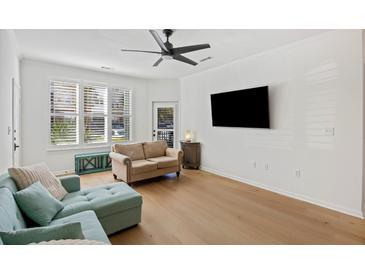 Bright living room featuring hardwood floors, a ceiling fan, and comfortable seating at 200 Bucksley Ln # 105, Charleston, SC 29492
