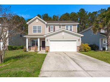 Charming two-story home with a well-manicured lawn and a spacious two-car garage at 206 Woodbrook Way, Moncks Corner, SC 29461