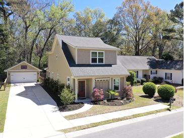 Charming two-story home with well-manicured lawn, red door, and detached garage with basketball hoop at 263 Stefan Dr, Charleston, SC 29412