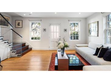 Bright living room featuring hardwood floors, contemporary furnishings, and natural light from large windows at 301 Broad St # 1, Charleston, SC 29401