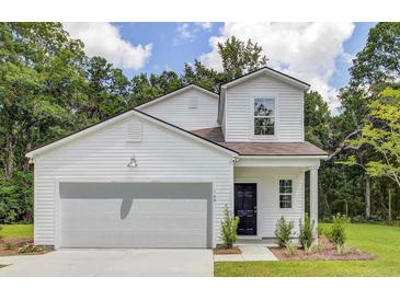 Charming two-story home with white siding, a garage, and manicured landscaping at 313 Pine Crest View Dr, Summerville, SC 29486
