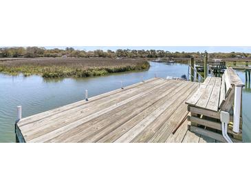 Waterfront home featuring a private wooden dock with deep water access, perfect for boating and enjoying the scenic views at 741 Creekside Dr, Mount Pleasant, SC 29464