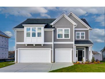 Charming two-story home featuring a gray exterior, two-car garage, and a welcoming front door at 118 Seaton Street, Summerville, SC 29486