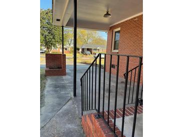 Inviting brick porch with black metal railing and supports, perfect for relaxing outdoors at 1236 Fort Dr, Hanahan, SC 29410