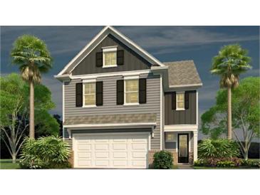 Charming two-story home featuring symmetrical window placement and an attached white two-car garage at 182 E Pinckney St, Lincolnville, SC 29485