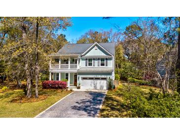 Charming two-story home featuring a welcoming front porch, a well-maintained lawn, and a private driveway at 2107 Nicholas David Path, Johns Island, SC 29455