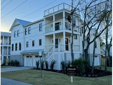 Stunning three-story coastal home with a rooftop deck and meticulous landscaping showcasing modern elegance at 2607 Cameron Blvd, Isle of Palms, SC 29451