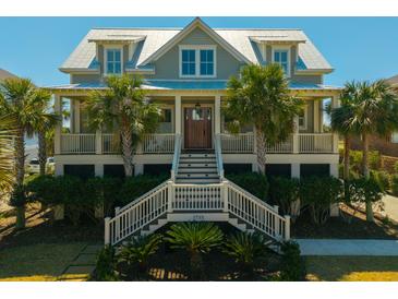 Charming coastal home with a welcoming front porch, beautiful landscaping and palm trees at 2722 Crooked Stick Ln, Mount Pleasant, SC 29466