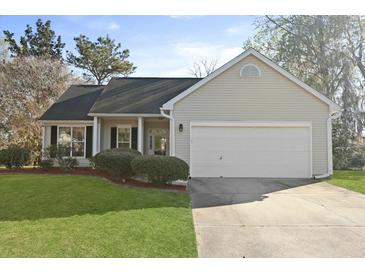 Charming single-story home with a well-manicured lawn and an attached two-car garage at 3438 Farmers Market Dr, Charleston, SC 29414
