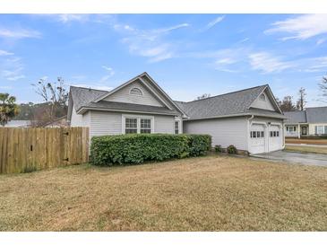 Charming single-story home featuring a two-car garage, well-maintained lawn, and classic architectural details at 346 Courtney Round, Summerville, SC 29483