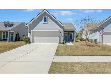 Charming single-Gathering home with a two-car garage and a well-manicured lawn on a sunny day at 422 Switchgrass Dr, Summerville, SC 29486