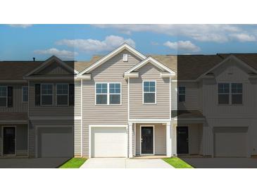 Charming home featuring a well-maintained lawn, attached garage, and light gray siding at 508 Golden Embers Way, Summerville, SC 29486