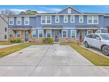 Charming townhomes featuring stone accents, blue siding, and a convenient two-car driveway at 7803 Park Gate Dr, Charleston, SC 29418