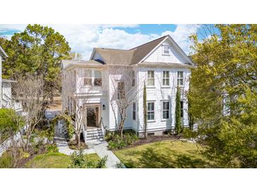 Charming two-story home featuring a landscaped yard and inviting walkway to the front door at 873 Tupelo Bay Dr, Mount Pleasant, SC 29464