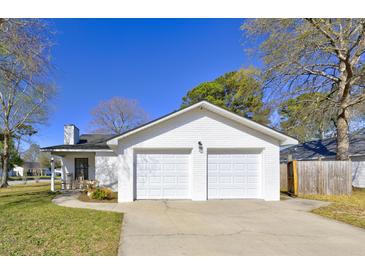 Charming home featuring an attached two-car garage and classic painted brick at 9861 Levenshall Dr, Ladson, SC 29456