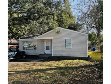 Charming single-story home with a cozy front porch and mature trees at 1255 Remount Rd, North Charleston, SC 29406