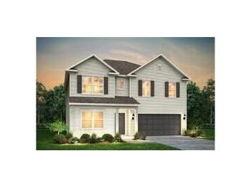 Charming two-story home with symmetrical windows, black shutters, an attached two car garage, and a landscaped yard at 128 Royal Cainhoy Way, Huger, SC 29450