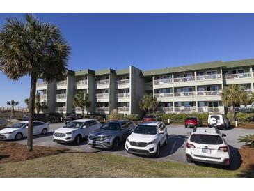 Multi-story condo building with balconies and well-maintained parking area and landscaping at 1300 Ocean Blvd # 139, Isle of Palms, SC 29451