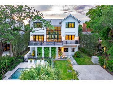 Stunning two-story modern farmhouse with a lush yard, pool, and a unique vertical garden at 204 E Huron Ave, Folly Beach, SC 29439