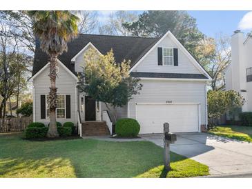Charming two-story home with a well-maintained lawn, mature landscaping, and an attached two-car garage at 2050 S Smokerise Way, Mount Pleasant, SC 29466