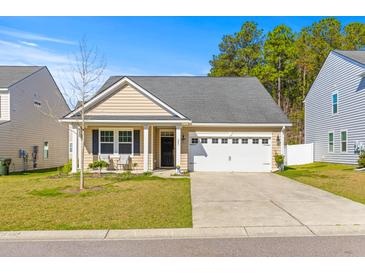 Charming single-story home with tan siding, black shutters, and an attached white single-car garage at 223 Sugarberry Lane, Moncks Corner, SC 29461