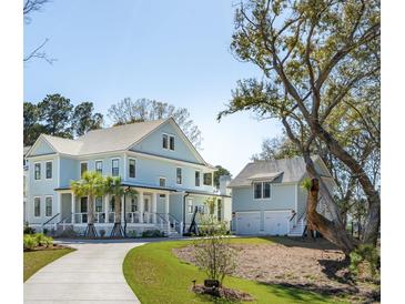 Charming two-story home with a lush landscaped yard and a detached garage at 3894 Sawyers Island Dr, Mount Pleasant, SC 29466