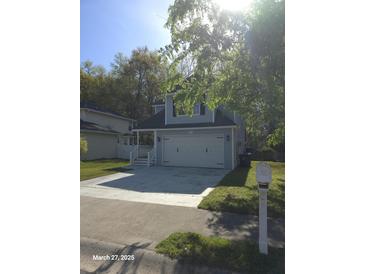 Charming two-story home featuring a two-car garage, a well-kept lawn, and traditional architectural details at 399 Stefan Dr, Charleston, SC 29412