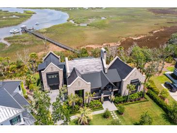 Stunning waterfront home with private dock and lush landscaping, boasting luxurious coastal living at 430 Fish Tale Rd, Charleston, SC 29492