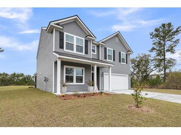 Charming two-story home featuring gray siding, black shutters and a two-car garage at 5115 Cranesbill Way, Johns Island, SC 29455