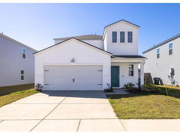 Charming two-story home featuring white siding, a two-car garage, and a well-maintained front yard at 538 Spanish Wells Rd, Summerville, SC 29486