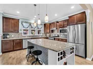 Bright kitchen features stainless steel appliances, granite countertops, wine rack, and a large island with seating at 614 Battery Edge Dr, Summerville, SC 29486