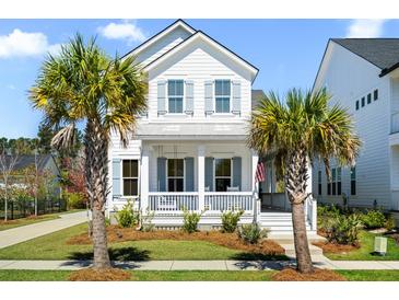 Charming two-story white home with a welcoming front porch and lush landscaping with palm trees in a quiet neighborhood at 1772 Agate Bay Dr, Mount Pleasant, SC 29466