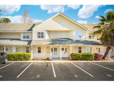 Inviting townhouse with charming front porch, green landscaping, and designated parking at 270 Stefan Dr # 11-C, Charleston, SC 29412