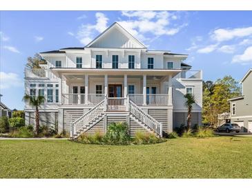 Elegant two-story home boasting a covered front porch, white railing, and beautifully landscaped yard at 2912 Yachtsman Dr, Mount Pleasant, SC 29466