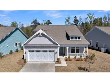 Charming home featuring a two-car garage, front porch, and lovely landscaping at 4075 Aspera Dr, Summerville, SC 29483