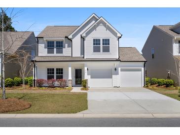 Charming two-story home featuring a two-car garage, well-maintained lawn, and inviting front porch at 410 Avocet Dr, Summerville, SC 29486