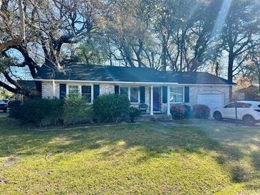 Charming single-story home with brick exterior and well-maintained lawn at 4228 Oakridge Dr, North Charleston, SC 29418