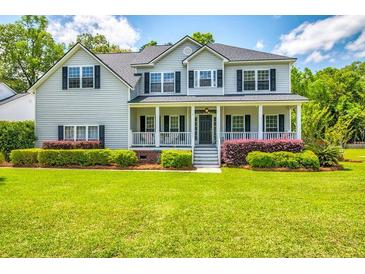 Charming two-story home with manicured lawn and inviting front porch at 5556 Indigo Fields Blvd, North Charleston, SC 29418