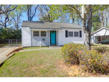 Charming single-story home featuring a bright blue front door and freshly painted white siding at 5801 Chaucer Dr, Hanahan, SC 29410