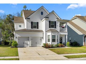 Charming two-story home with a two-car garage, a balcony, and a well-manicured front yard at 6005 Coral Berry Rd, Hanahan, SC 29410
