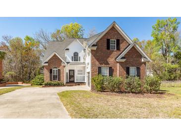 Charming two-story brick home with well-maintained landscaping and a welcoming front porch at 104 Abrum Ct, Goose Creek, SC 29445