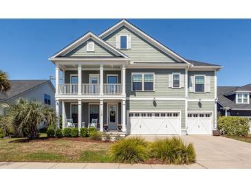 Charming two-story home with a double front porch and manicured landscaping at 1166 Elliotts Cut Dr, Charleston, SC 29412