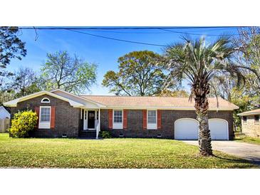 Charming brick ranch with red shutters and a well-maintained front yard with mature trees at 1198 Oakcrest Dr, Charleston, SC 29412