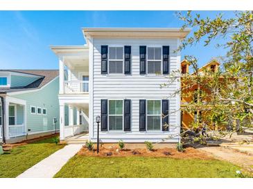 Charming two-story home featuring a bright white exterior with black shutters and a cozy covered porch at 125 Cantona Dr, Summerville, SC 29483