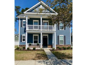 Charming two-story home with a welcoming front porch and blue siding at 1659 Seabago Dr, Charleston, SC 29414
