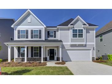 Charming two-story home with gray siding, black shutters, and a covered front porch at 111 Grange Cir, Summerville, SC 29486