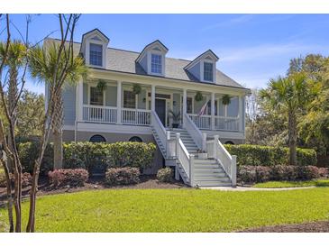 Charming two-story home featuring a welcoming front porch and well-manicured landscaping at 1367 N Edgewater Dr, Charleston, SC 29407