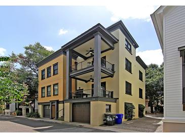 View of the home featuring a three-story facade with balconies, private garage and modern architectural design at 15 Corinne St # B, Charleston, SC 29403